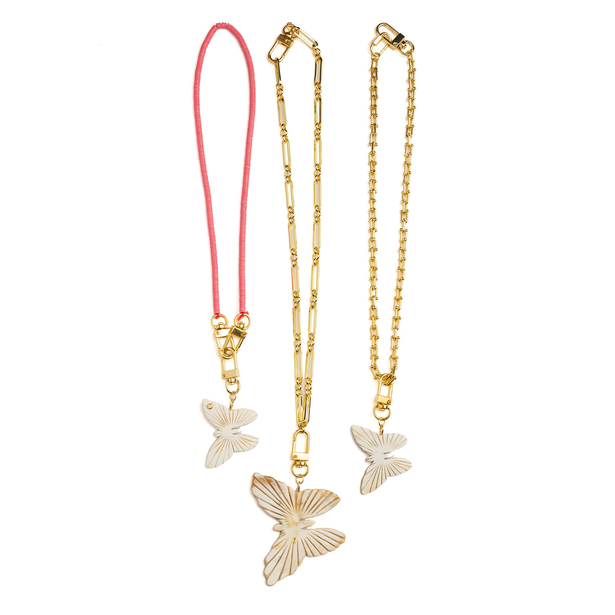 Pair of Akola hand-carved horn butterfly charms displayed together