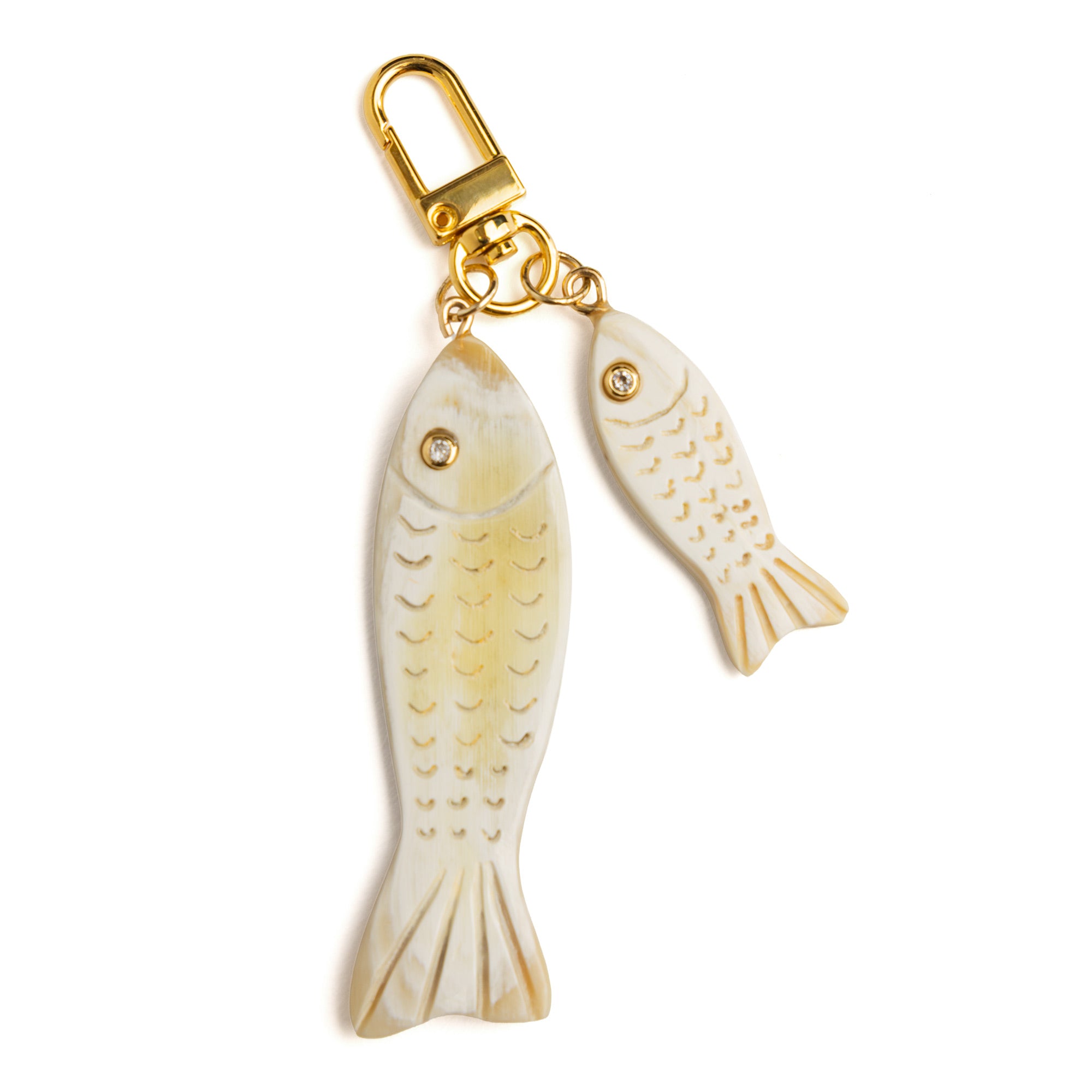 Detail of Akola hand-carved double fish horn charm showing natural striations