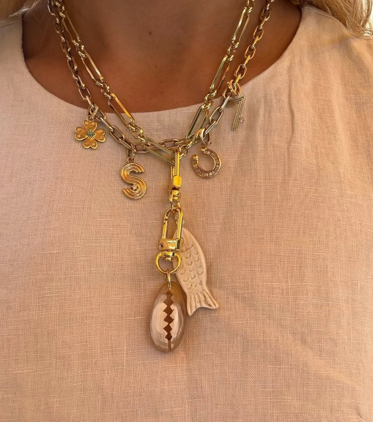 Akola cowrie charm in hand-carved horn, lifestyle shot