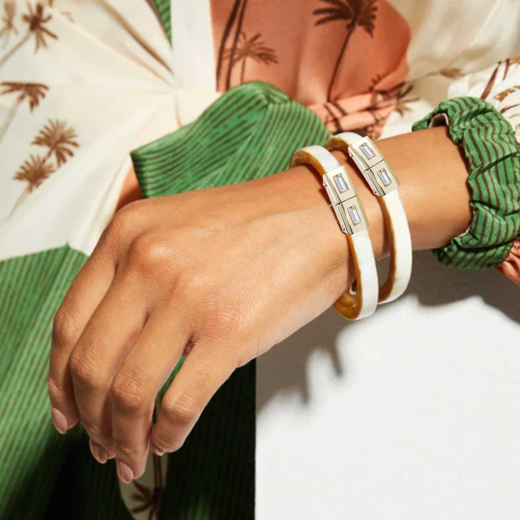 Multiple Unlock-it Bracelets on a woman's wrist