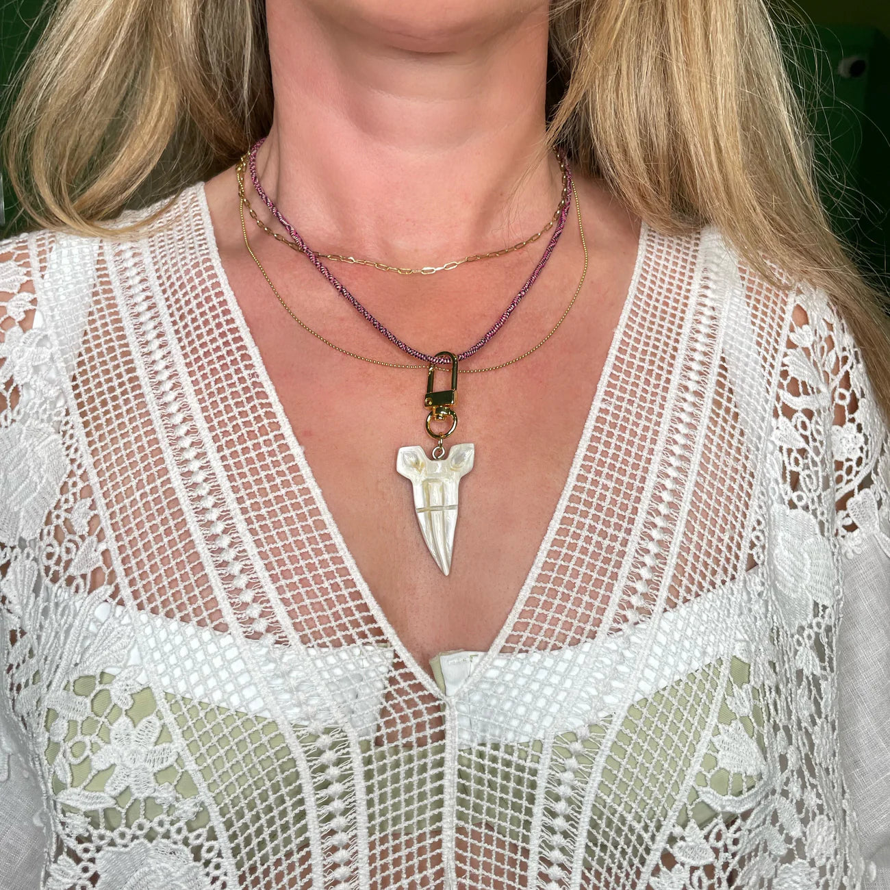 Akola shark tooth charm on a braided raffia cord