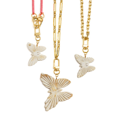 Akola butterfly charms in light caramel and dark brown hand-carved horn