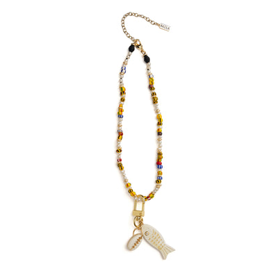 Side view of Akola petite fish and cowrie horn charm