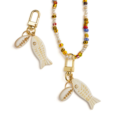 Detail of Akola hand-carved fish and cowrie horn charm