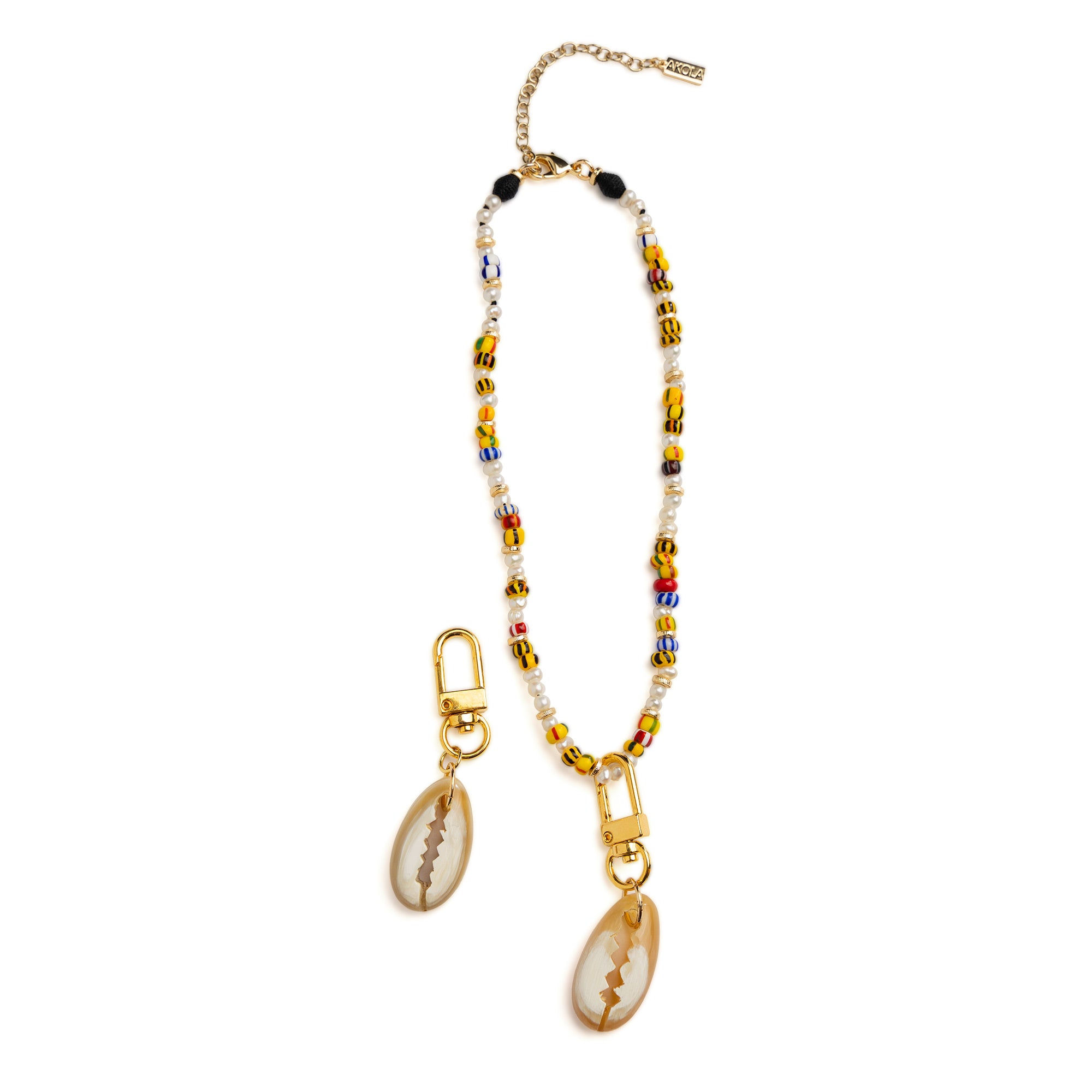 Akola cowrie horn charm with 18k gold-plated clasp detail