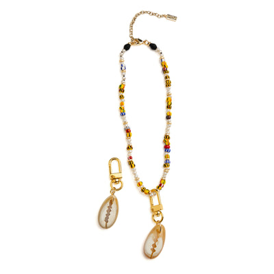 Akola cowrie horn charm with 18k gold-plated clasp detail