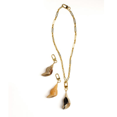 Akola conch shell horn charm showing natural striations
