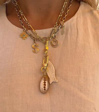 Akola cowrie charm in hand-carved horn, lifestyle shot
