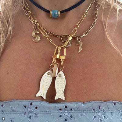 Akola petite fish and cowrie charm in hand-carved horn