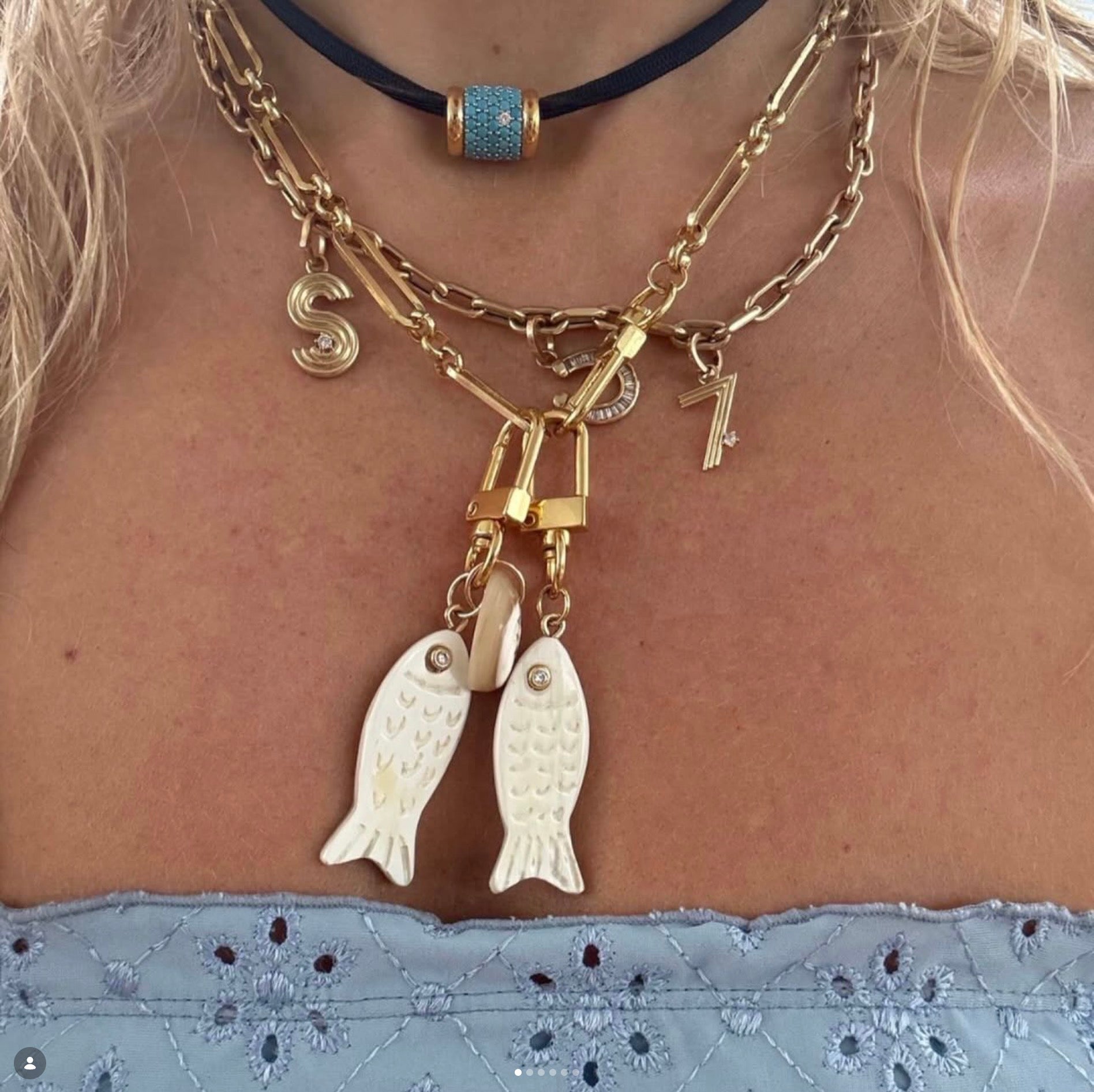 Akola Bahari Collection horn fish and cowrie charms styled together
