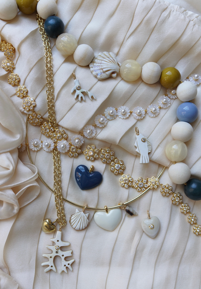 Jewelry set with necklaces and bracelets on a textured surface