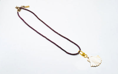 Akola horn sea shell charm on a braided raffia cord