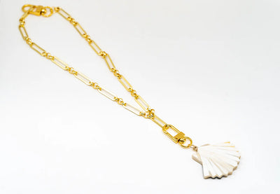 Akola sea shell horn charm on a gold paperclip chain